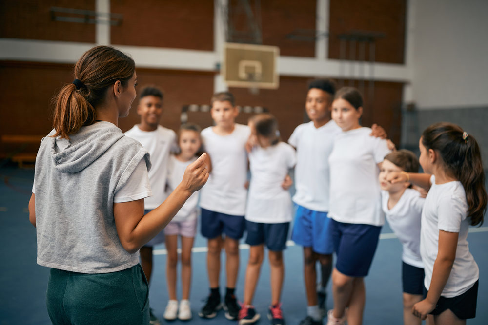 Back,View,Of,Female,Pe,Teacher,Explaining,Exercise,Activities,To Back,View,Of,Female,Pe,Teacher,Explaining,Exercise,Activities,To